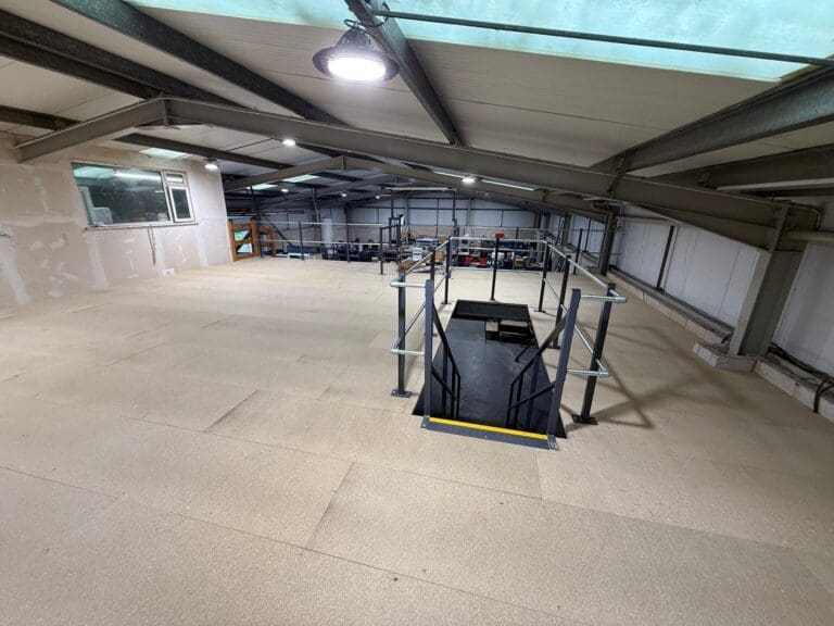 Upper deck of the completed mezzanine floor installation in Chesterfield with safety handrails and access staircase.